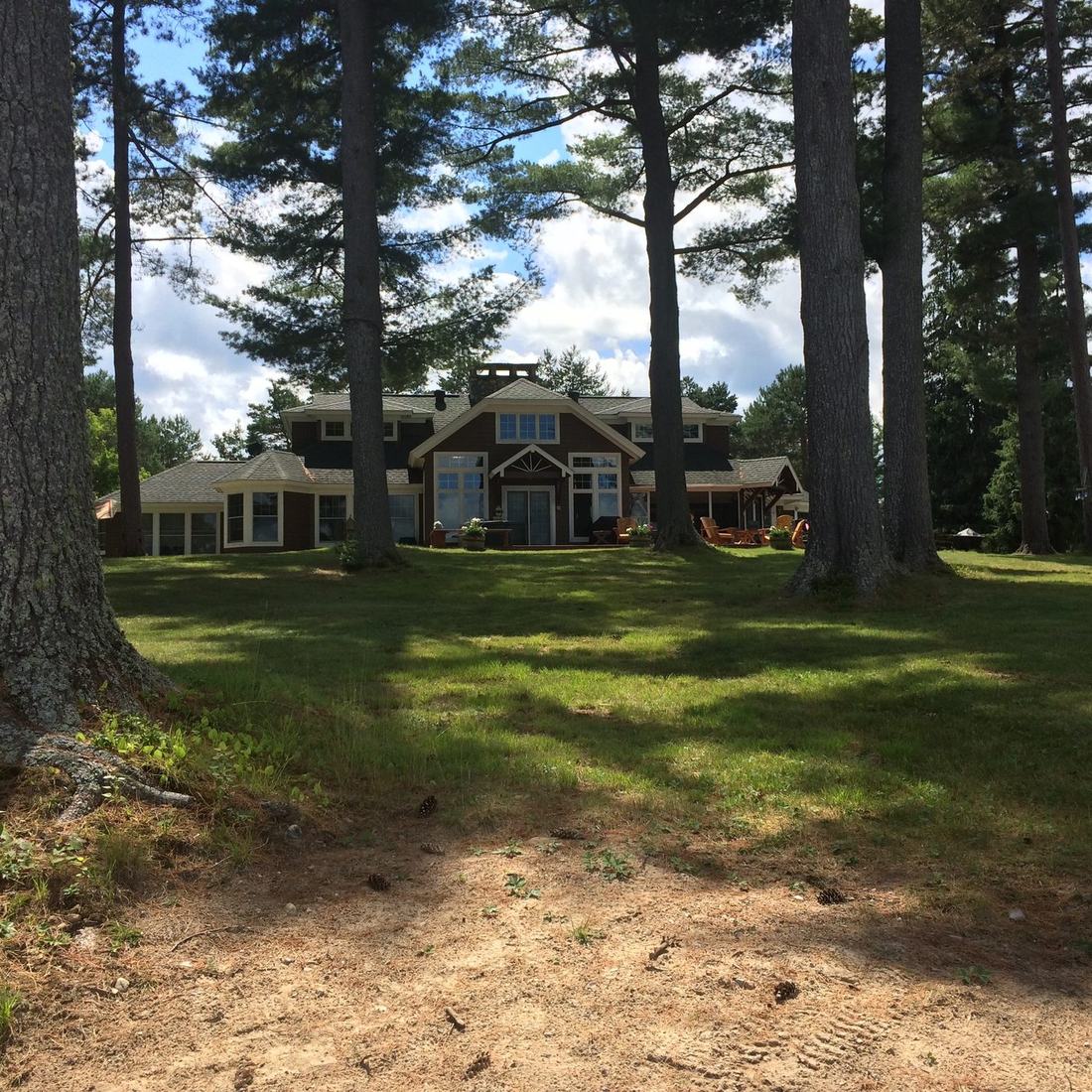 The lodge under tall pines beside the lake