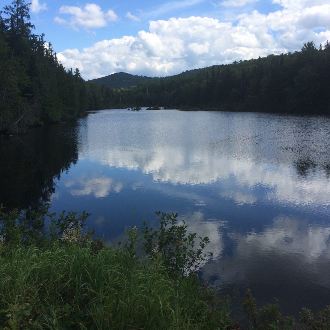 Still lake reflecting the hills and sky